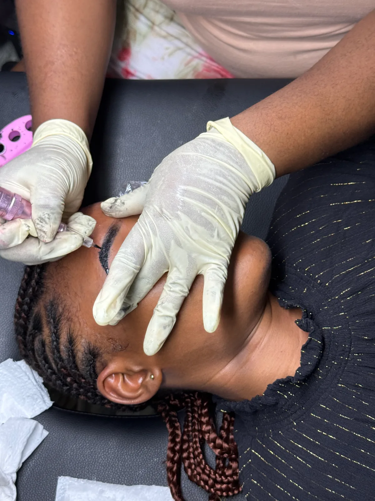 Hands applying lash extensions